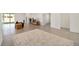 Spacious living room with large area rug, a view to the kitchen and patio, and tiled floor at 6071 Sw 93Rd Loop, Ocala, FL 34476