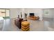 Bright living room with tile floors, a leather chair, and built-in shelving at 6071 Sw 93Rd Loop, Ocala, FL 34476