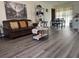 Living room with brown sofa, coffee table, and gray vinyl flooring at 8152 Sw 106Th St, Ocala, FL 34481