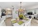 Bright dining area with kitchen views and chandelier at 8909 Se 90Th Avenue Rd, Ocala, FL 34472