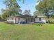 House exterior showcasing a pergola-covered patio and lawn at 965 Nw 73Rd Ter, Ocala, FL 34482