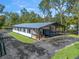 White metal barn with covered seating area and attached garage at 965 Nw 73Rd Ter, Ocala, FL 34482