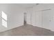 Well-lit bedroom with double door closet and access to hallway at 10330 Sw 99Th Ln, Ocala, FL 34481