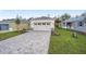 New construction home with a paved driveway and grassy lawn at 10330 Sw 99Th Ln, Ocala, FL 34481
