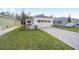 New construction home with a paved driveway and grassy lawn at 10330 Sw 99Th Ln, Ocala, FL 34481