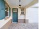 Inviting front door entrance with teal door and paver walkway at 10330 Sw 99Th Ln, Ocala, FL 34481