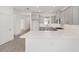 Modern kitchen with gray cabinets, white quartz countertops, and stainless steel appliances at 10330 Sw 99Th Ln, Ocala, FL 34481