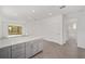 Open kitchen with gray cabinets, quartz island, and view into adjacent living area at 10330 Sw 99Th Ln, Ocala, FL 34481