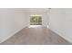 Bright living room with wood-look tile flooring and sliding glass doors at 10330 Sw 99Th Ln, Ocala, FL 34481