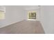Bright and spacious living room with wood-look tile flooring and sliding glass doors at 10330 Sw 99Th Ln, Ocala, FL 34481