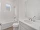 Bathroom with tub, toilet, and vanity with modern fixtures at 10338 Sw 99Th Ln, Ocala, FL 34481