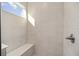 Shower with built-in seat and bright, modern tile at 10338 Sw 99Th Ln, Ocala, FL 34481