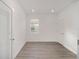 Bright bedroom with wood-look floors and an exterior view at 10338 Sw 99Th Ln, Ocala, FL 34481