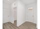 Bright entryway with wood-look floors, coat closet, and white doors at 10338 Sw 99Th Ln, Ocala, FL 34481