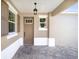 Front entry with wood door and paver flooring at 10338 Sw 99Th Ln, Ocala, FL 34481