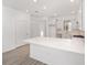 Modern kitchen with white cabinets, quartz countertops and island at 10338 Sw 99Th Ln, Ocala, FL 34481