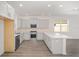 Modern kitchen with white cabinets, stainless steel appliances, and an island at 10338 Sw 99Th Ln, Ocala, FL 34481