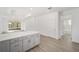 Open kitchen features island with seating and gray cabinets at 10338 Sw 99Th Ln, Ocala, FL 34481