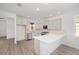 Modern kitchen with white cabinets and a large island at 10338 Sw 99Th Ln, Ocala, FL 34481