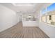 Modern kitchen with white cabinets, quartz countertops, and breakfast bar at 10338 Sw 99Th Ln, Ocala, FL 34481
