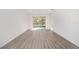 Bright living room with wood-look floors and access to a patio at 10338 Sw 99Th Ln, Ocala, FL 34481