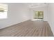 Spacious living room featuring wood-look floors and sliding glass doors at 10338 Sw 99Th Ln, Ocala, FL 34481