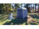 A storage shed and water pump in a backyard setting at 128 Cedar Rd, Ocala, FL 34472