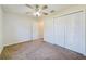 Bright bedroom with ceiling fan, carpet, and ample closet space at 128 Cedar Rd, Ocala, FL 34472