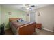 Charming bedroom with a queen-size bed and ceiling fan at 12887 Sw 31St Avenue Rd, Ocala, FL 34473