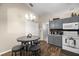 Eat-in kitchen with gray cabinets and wood flooring at 12887 Sw 31St Avenue Rd, Ocala, FL 34473