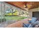 Covered back patio with tiled flooring, ceiling fan, and comfortable seating at 1416 Se 17Th Ave, Ocala, FL 34471