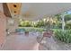 Spacious brick patio with seating area, fire pit, and backyard access at 1416 Se 17Th Ave, Ocala, FL 34471