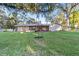 Large backyard with grassy lawn, mature trees, and a tire swing at 1416 Se 17Th Ave, Ocala, FL 34471