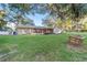 Expansive backyard featuring a grassy area and wooden swing at 1416 Se 17Th Ave, Ocala, FL 34471