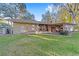 House backyard view with large lawn, patio, and mature trees at 1416 Se 17Th Ave, Ocala, FL 34471