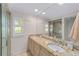 Double vanity bathroom with granite countertops and a walk-in shower at 1416 Se 17Th Ave, Ocala, FL 34471