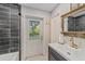 Bathroom with dark tile, a white sink and a door to the backyard at 1416 Se 17Th Ave, Ocala, FL 34471