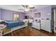 Cozy bedroom with purple walls, hardwood floors and ceiling fan at 1416 Se 17Th Ave, Ocala, FL 34471