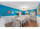 Spacious dining room with white table, blue walls, and hardwood floors at 1416 Se 17Th Ave, Ocala, FL 34471