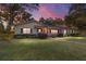 Ranch home at dusk with landscaped yard and walkway at 1416 Se 17Th Ave, Ocala, FL 34471