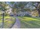 Ranch-style home with brick accents, mature trees, and a brick walkway at 1416 Se 17Th Ave, Ocala, FL 34471