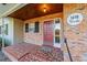 Inviting front porch with brick entryway and red door at 1416 Se 17Th Ave, Ocala, FL 34471