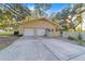 Attached two-car garage with double doors and long driveway at 1416 Se 17Th Ave, Ocala, FL 34471