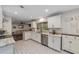 Updated kitchen boasts white cabinets, granite counters, and a stylish hexagon tile floor at 1416 Se 17Th Ave, Ocala, FL 34471