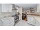 Modern kitchen with white cabinets, gold accents, and stainless steel appliances at 1416 Se 17Th Ave, Ocala, FL 34471