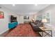 Spacious living room with dark hardwood floors, comfy seating, and large TV at 1416 Se 17Th Ave, Ocala, FL 34471