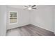 Bright bedroom with ceiling fan, large window, and gray flooring at 18 Juniper Drive Crse, Ocala, FL 34480