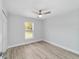 Bright bedroom with ceiling fan, large window, and wood-look floors at 1877 Sw 150 Ct, Ocala, FL 34481