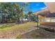 Spacious backyard with grassy area, trees, and shed at 21 Se Ocale Way, Summerfield, FL 34491