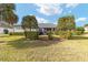 Backyard with lush grass, screened patio, and hedges at 2699 Nw 58Th Terrace, Ocala, FL 34482